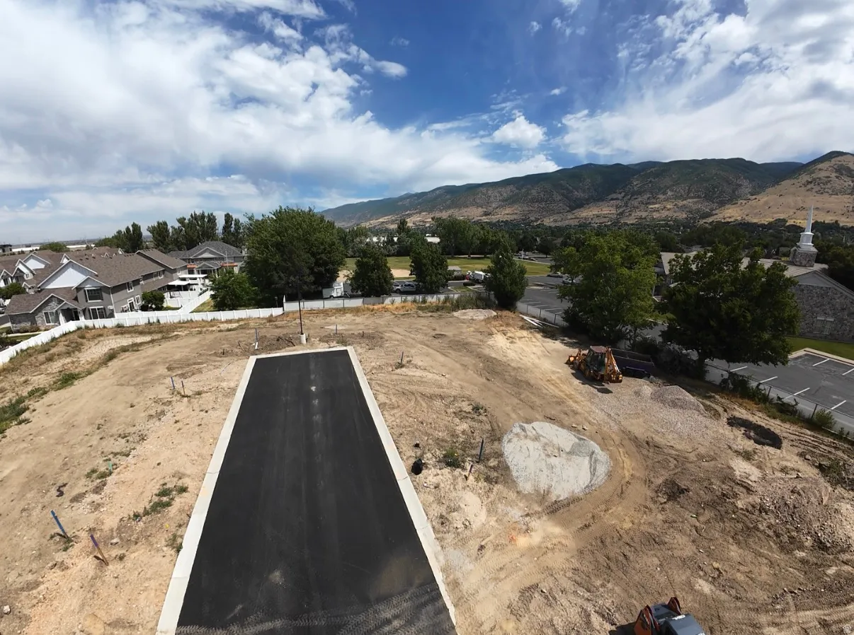 Graded lot with a paved driveway and mountain backdrop