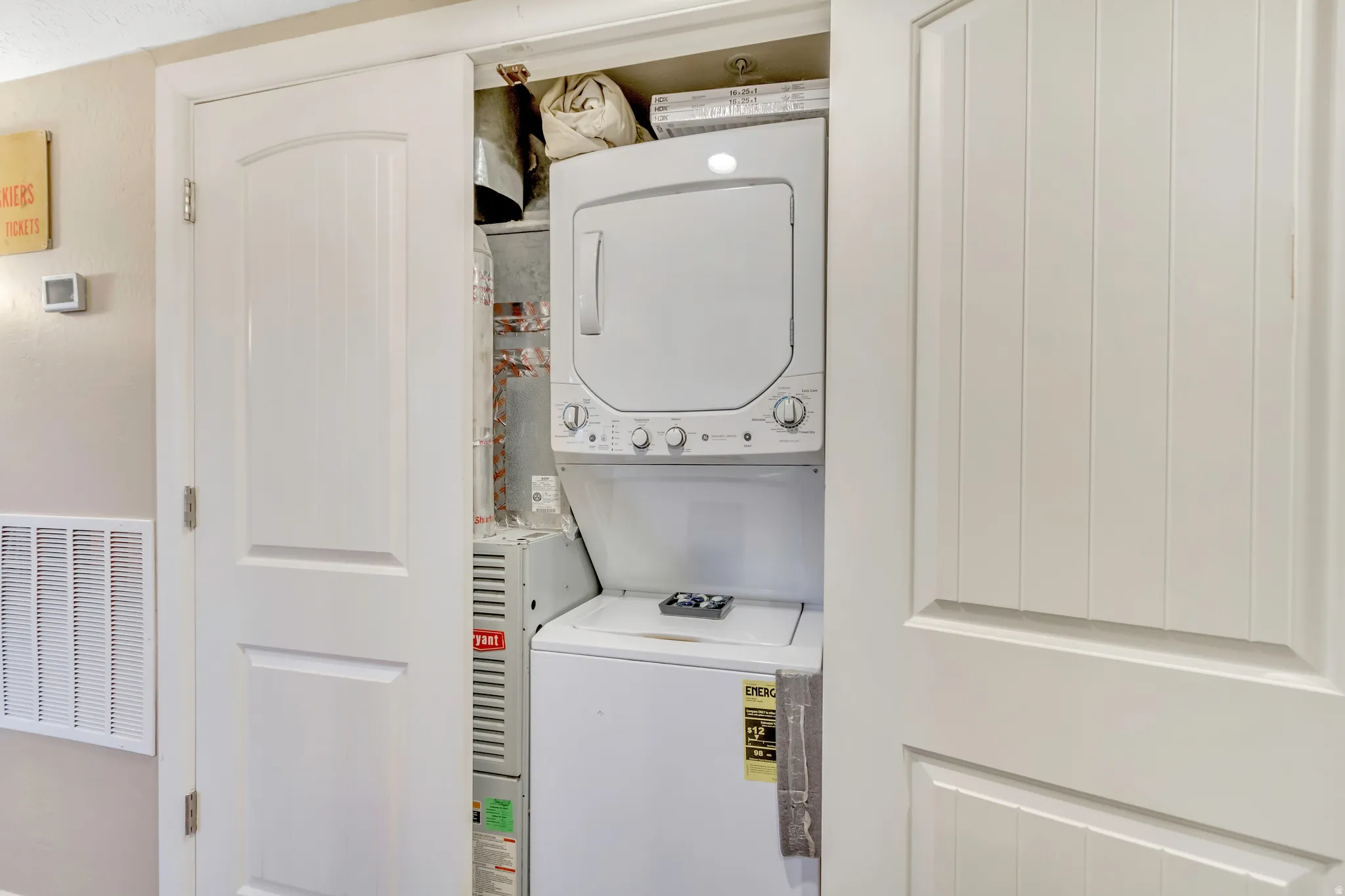 Laundry area featuring estacked washer and dryer
