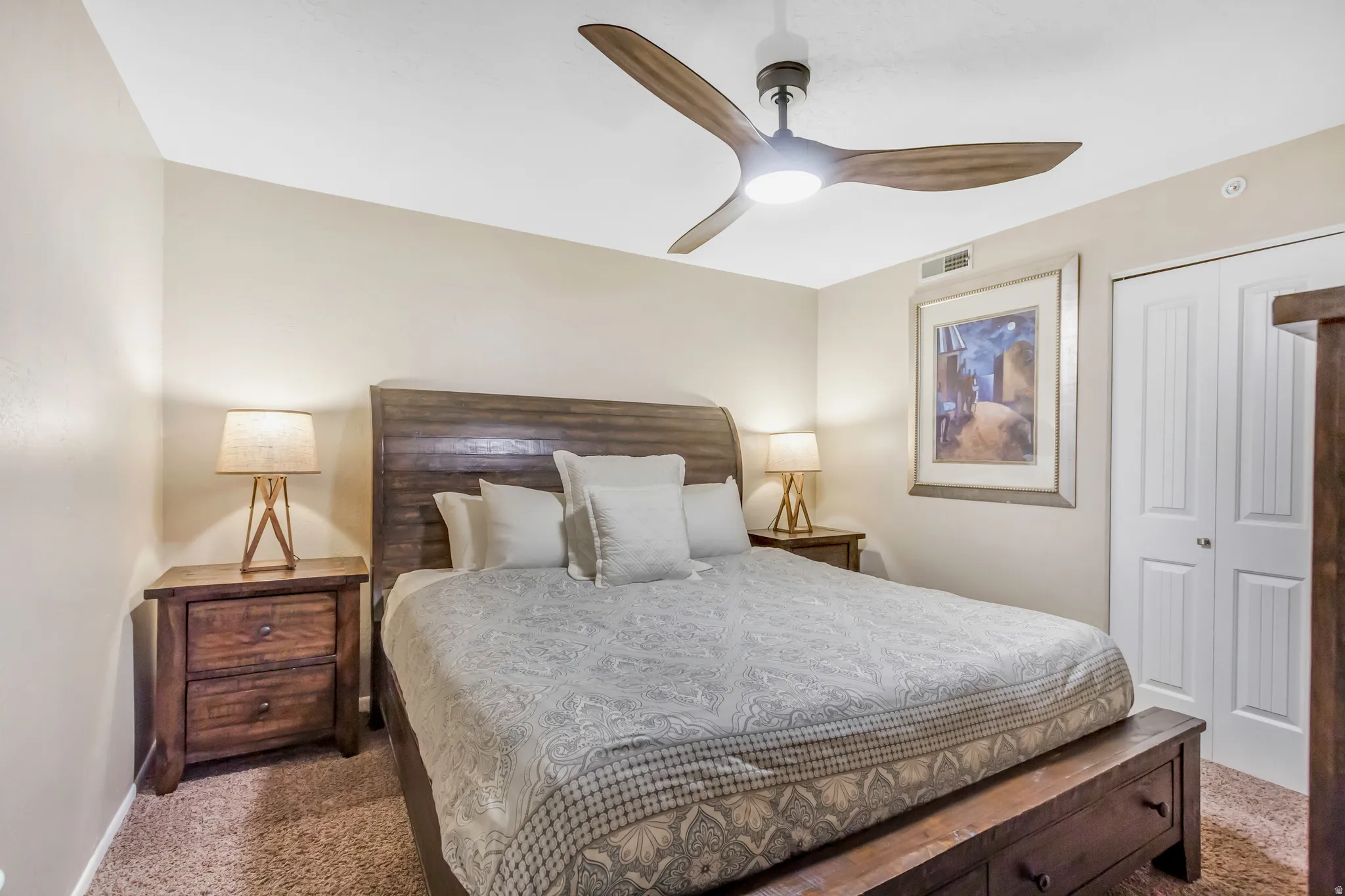 Bedroom with carpet flooring, a closet, and ceiling fan