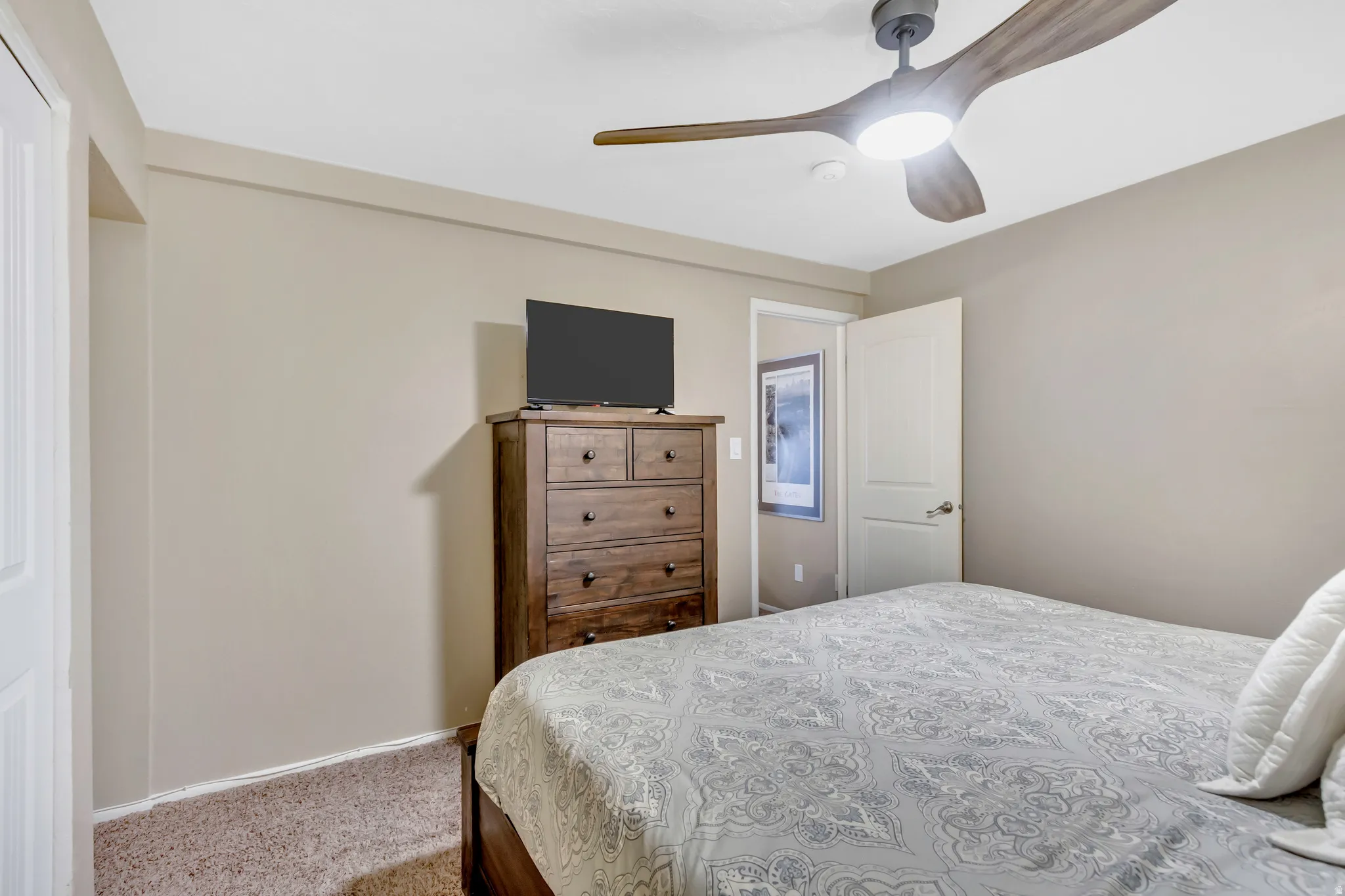 Bedroom with carpet floors and a ceiling fan