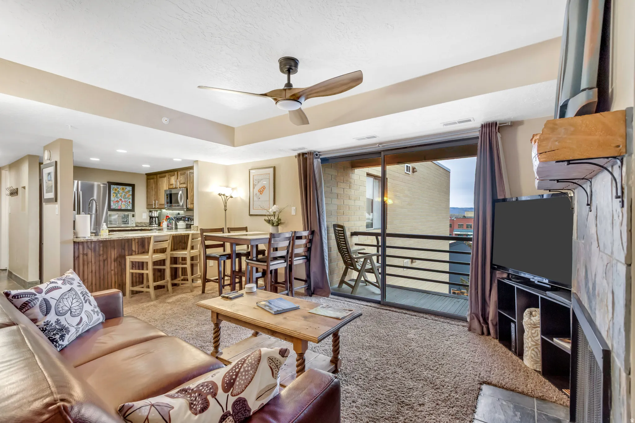 Living room with light colored carpet and ceiling fan