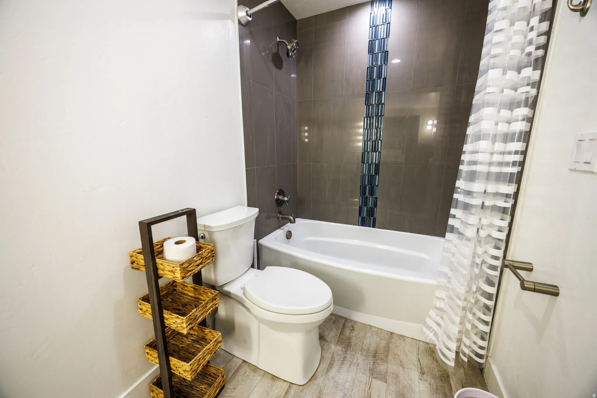Full bathroom featuring shower / tub combo with curtain and wood finished floors