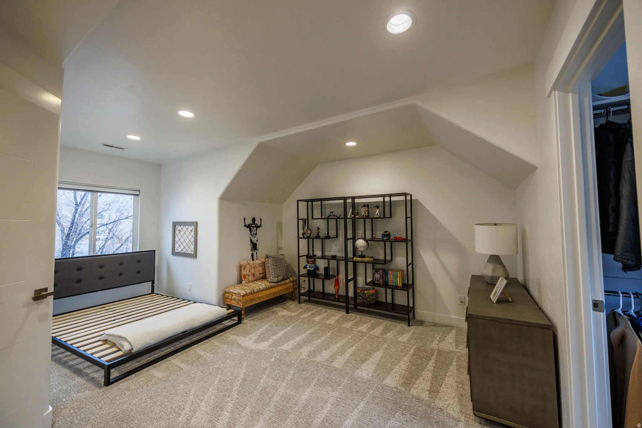 Carpeted bedroom with recessed lighting and vaulted ceiling