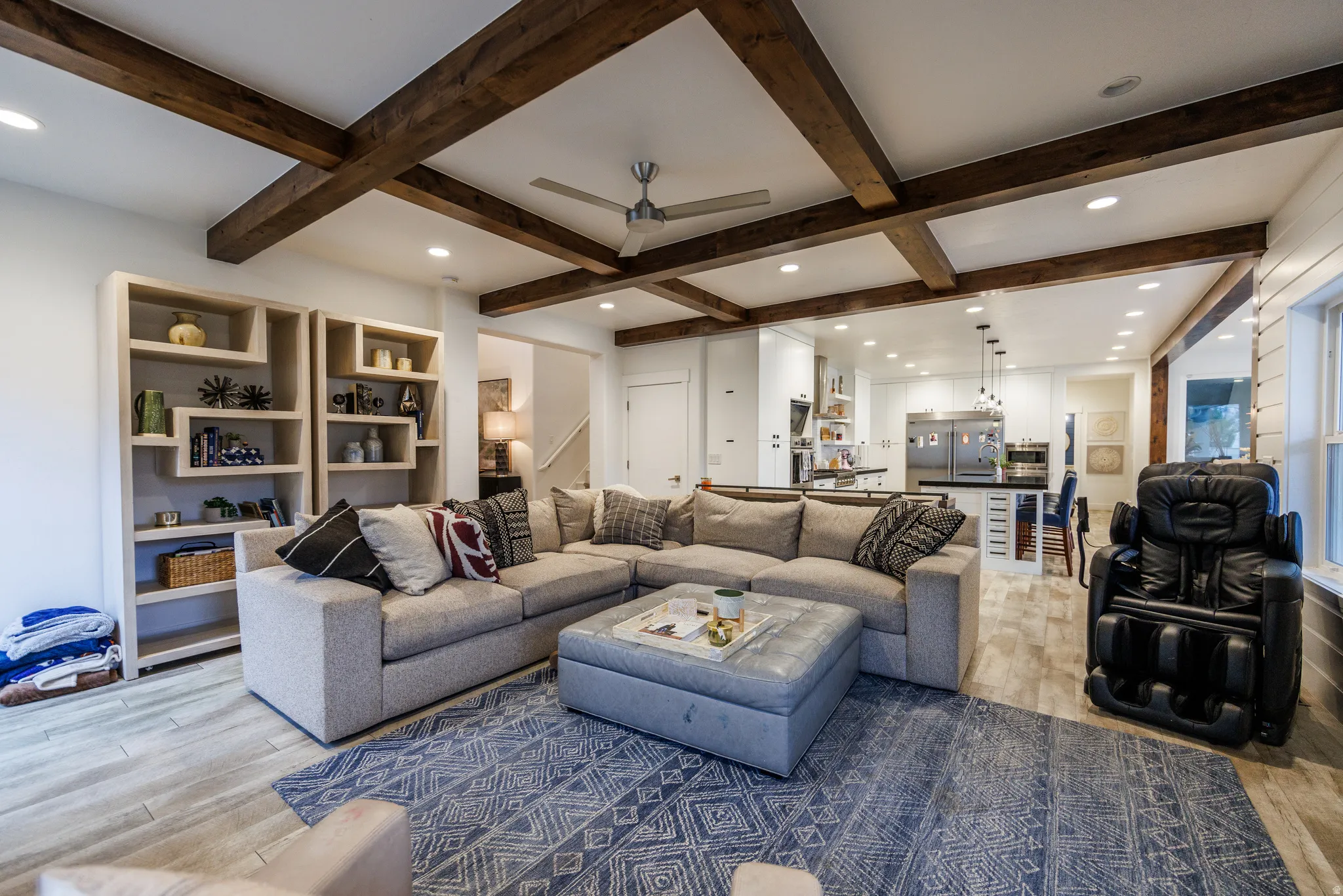Living room featuring ceiling fan, light wood-style flooring, recessed lighting, and coffered ceiling