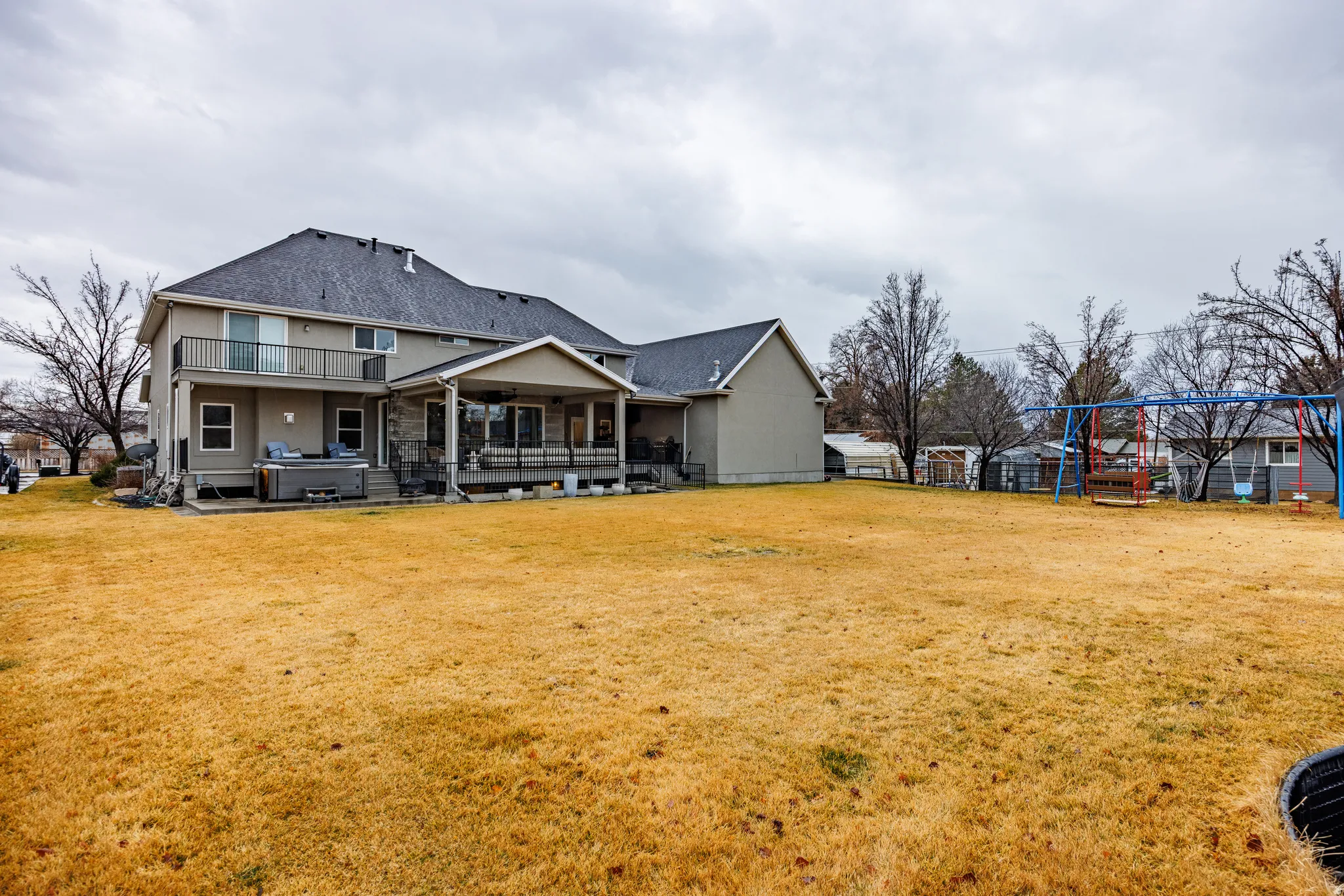 Rear view of property featuring a patio and ceiling fan