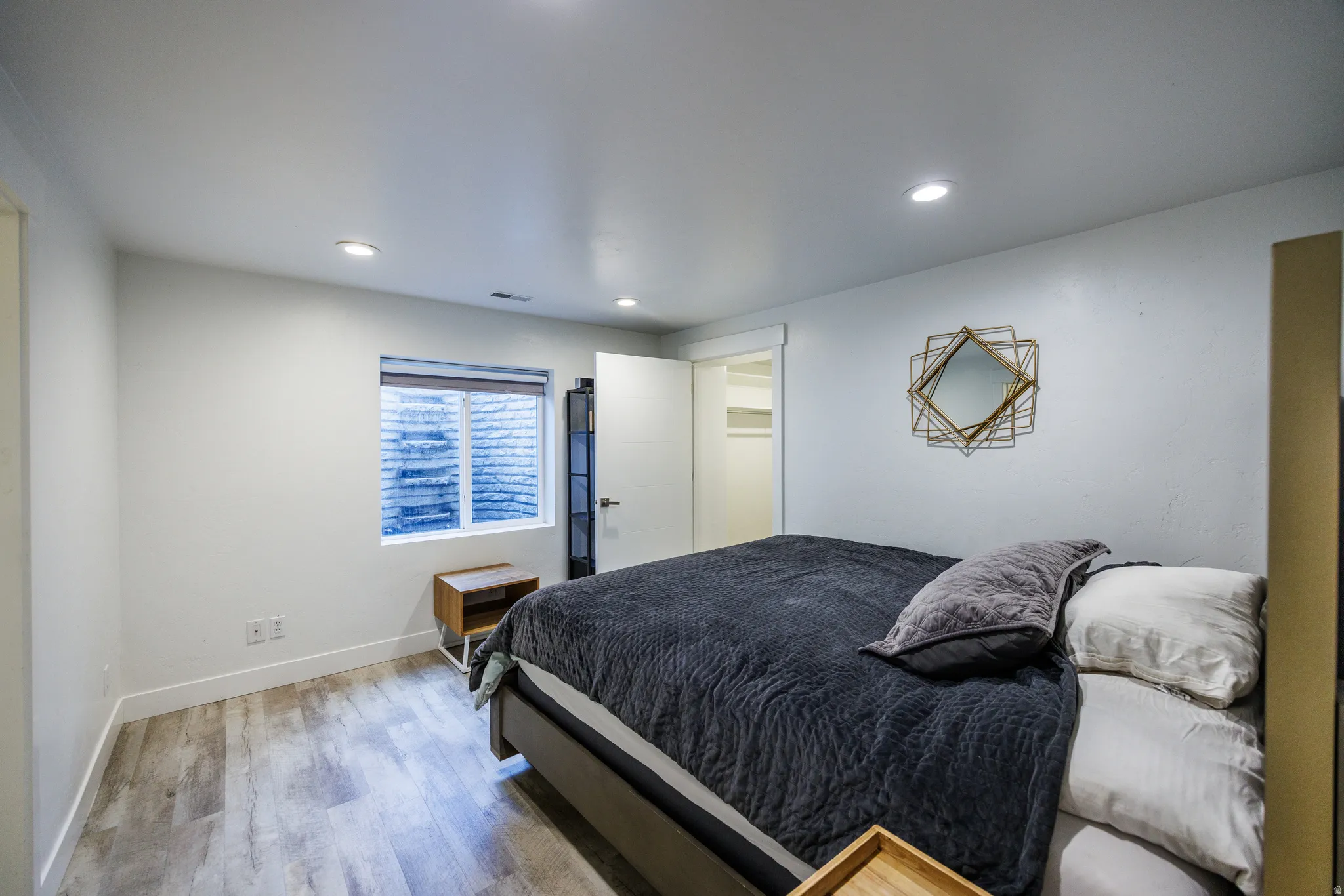 Bedroom featuring wood finished floors and recessed lighting