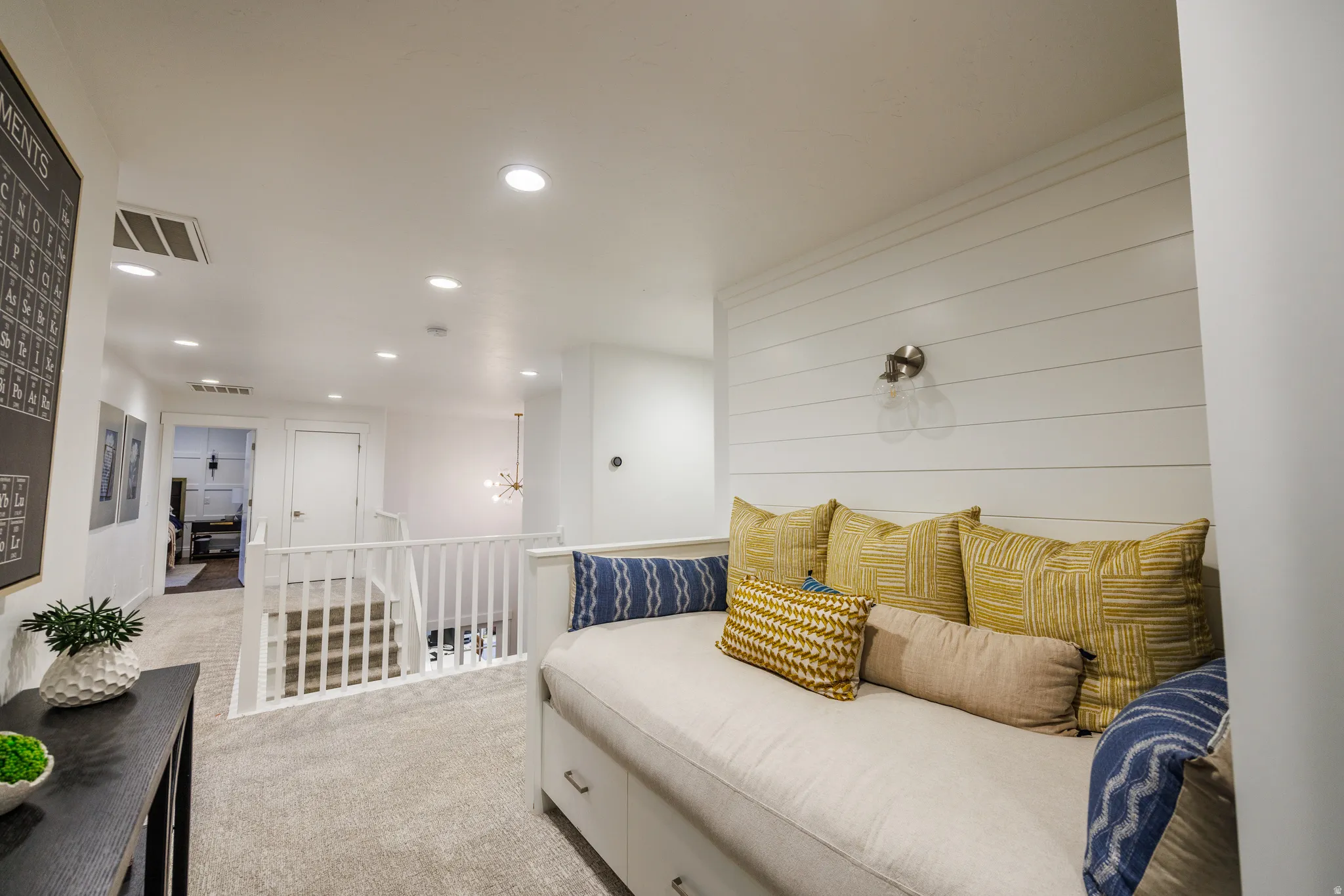 Sitting room with light carpet, recessed lighting, and an upstairs landing