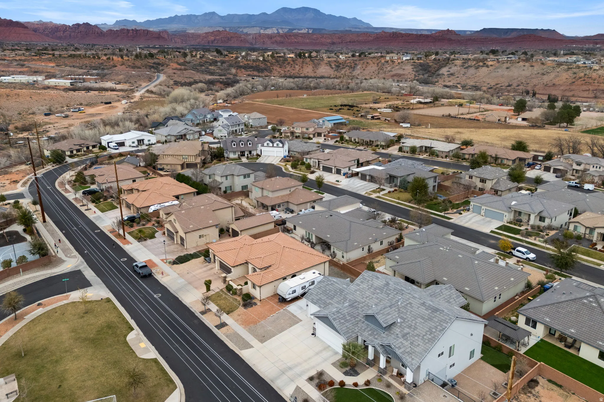 Aerial overview of property's location with a mountainous background and nearby suburban area