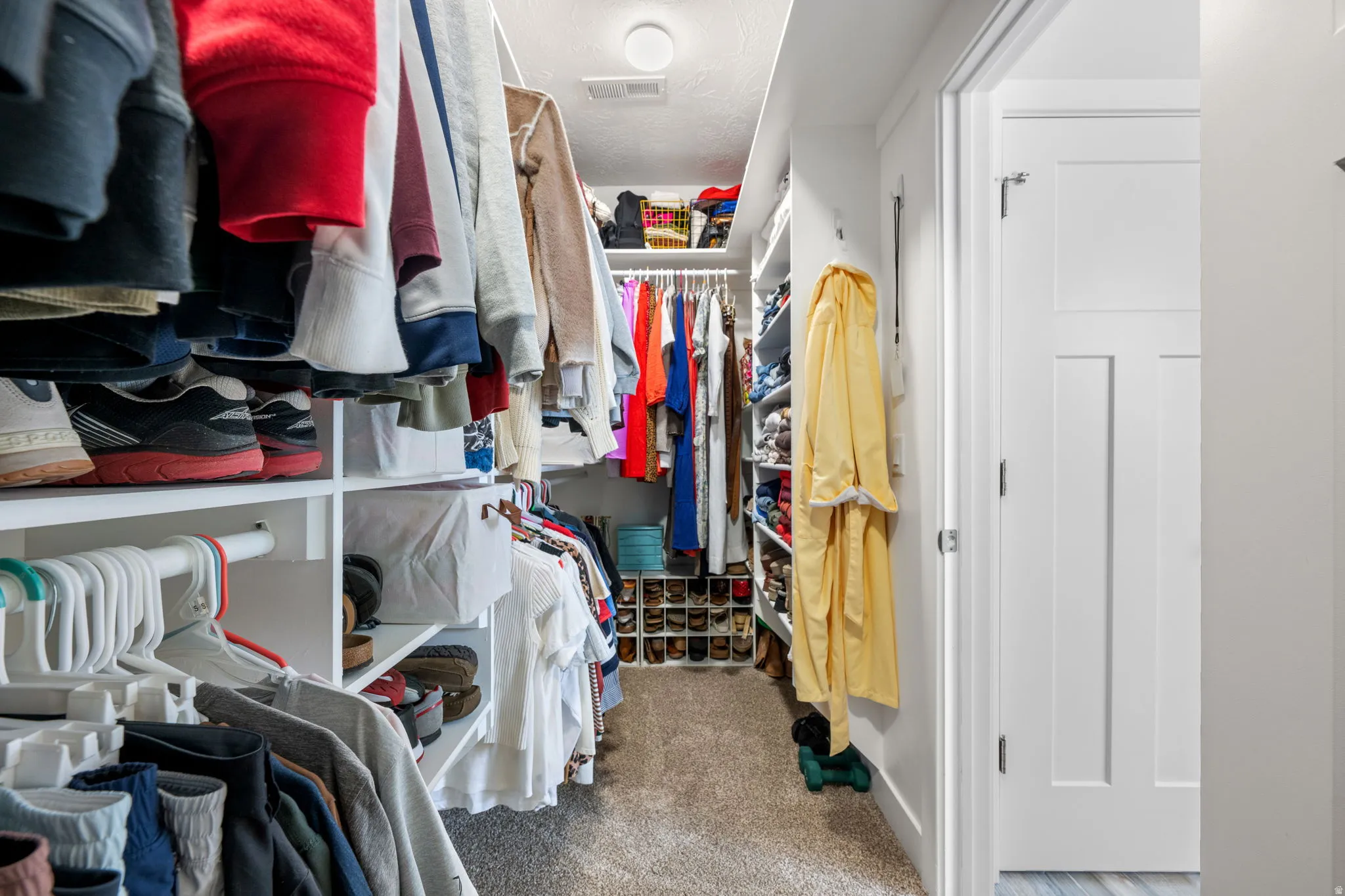 Walk in closet featuring light carpet