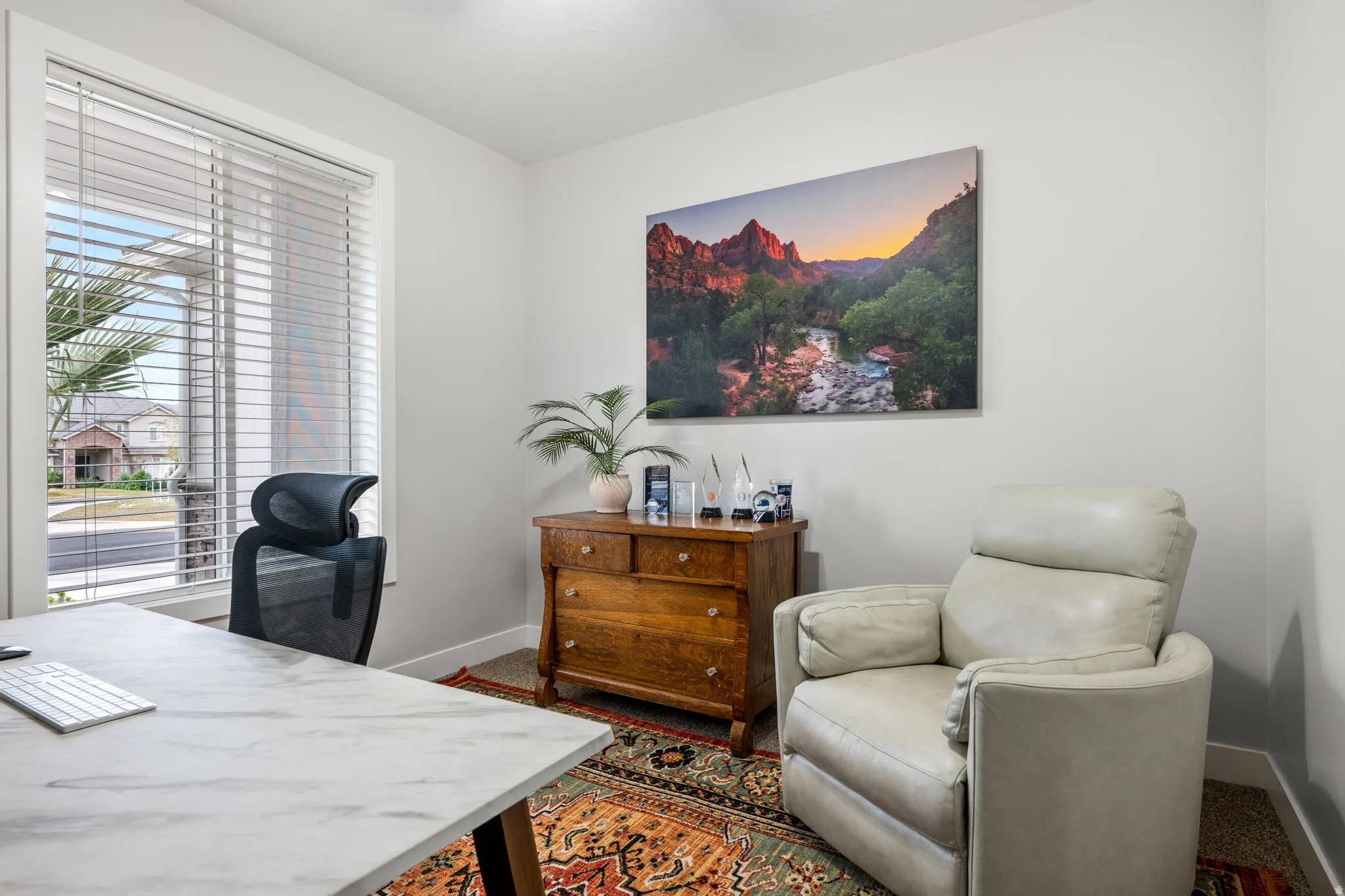 Home office with baseboards and dark colored carpet