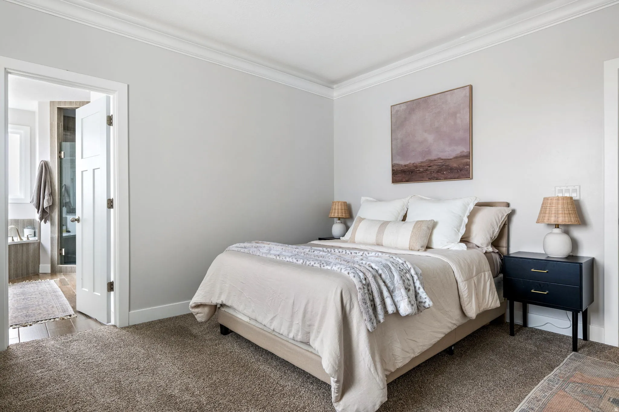Bedroom featuring crown molding, carpet flooring, and ensuite bath