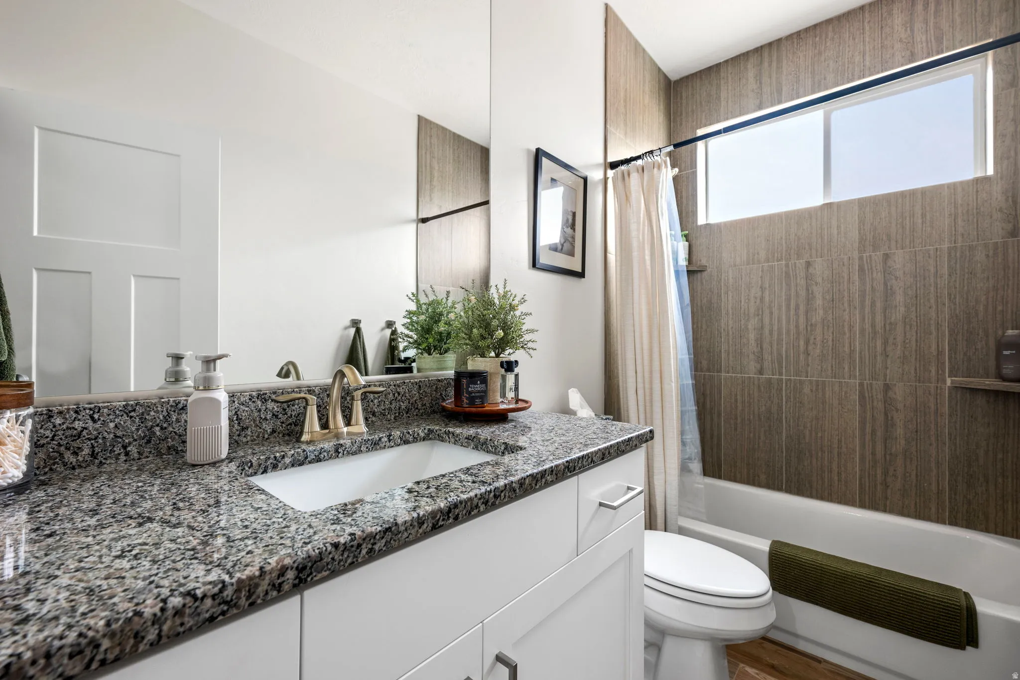 Bathroom with vanity and shower / tub combo