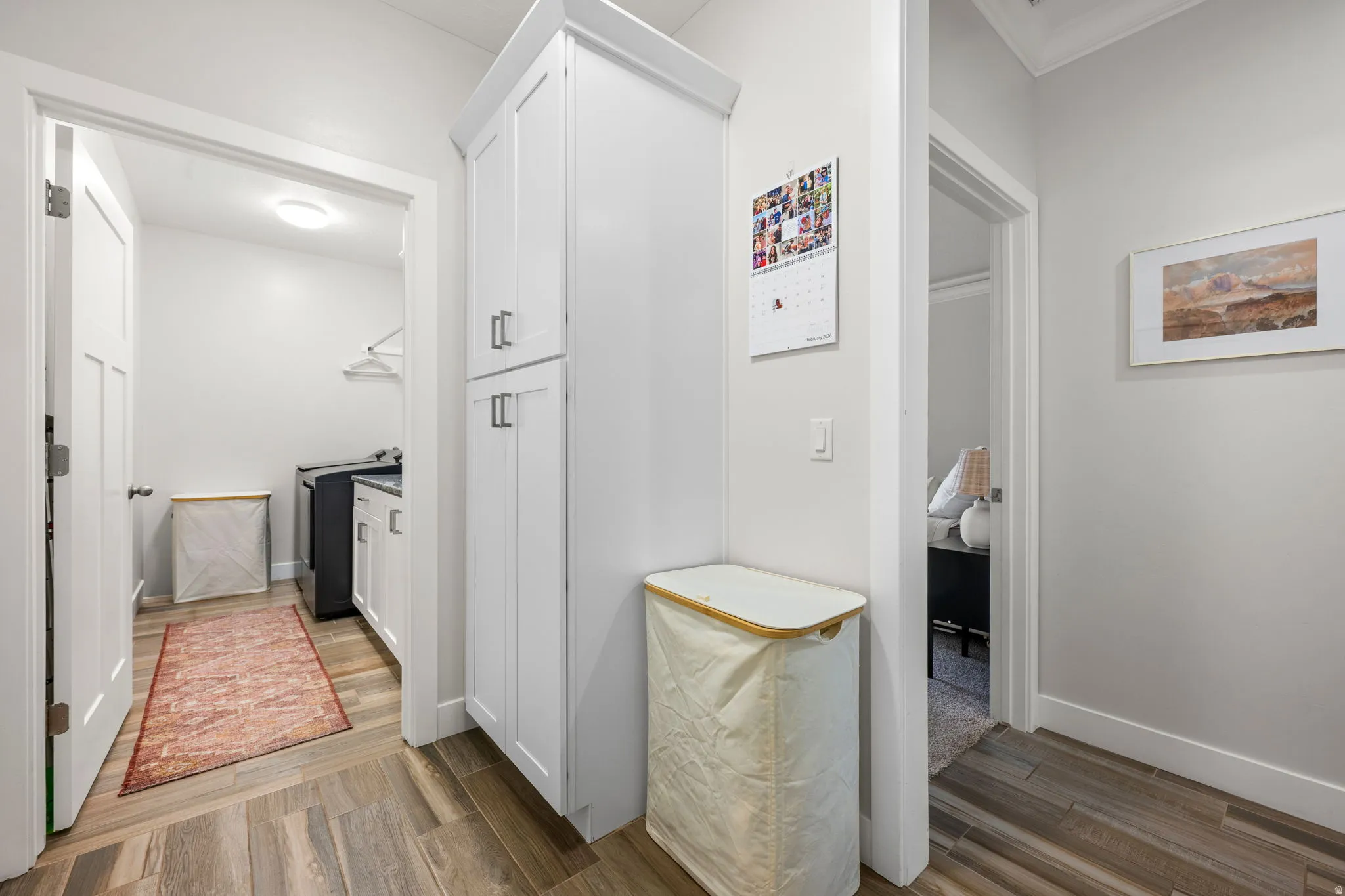 Corridor with light wood-style flooring and washer / dryer
