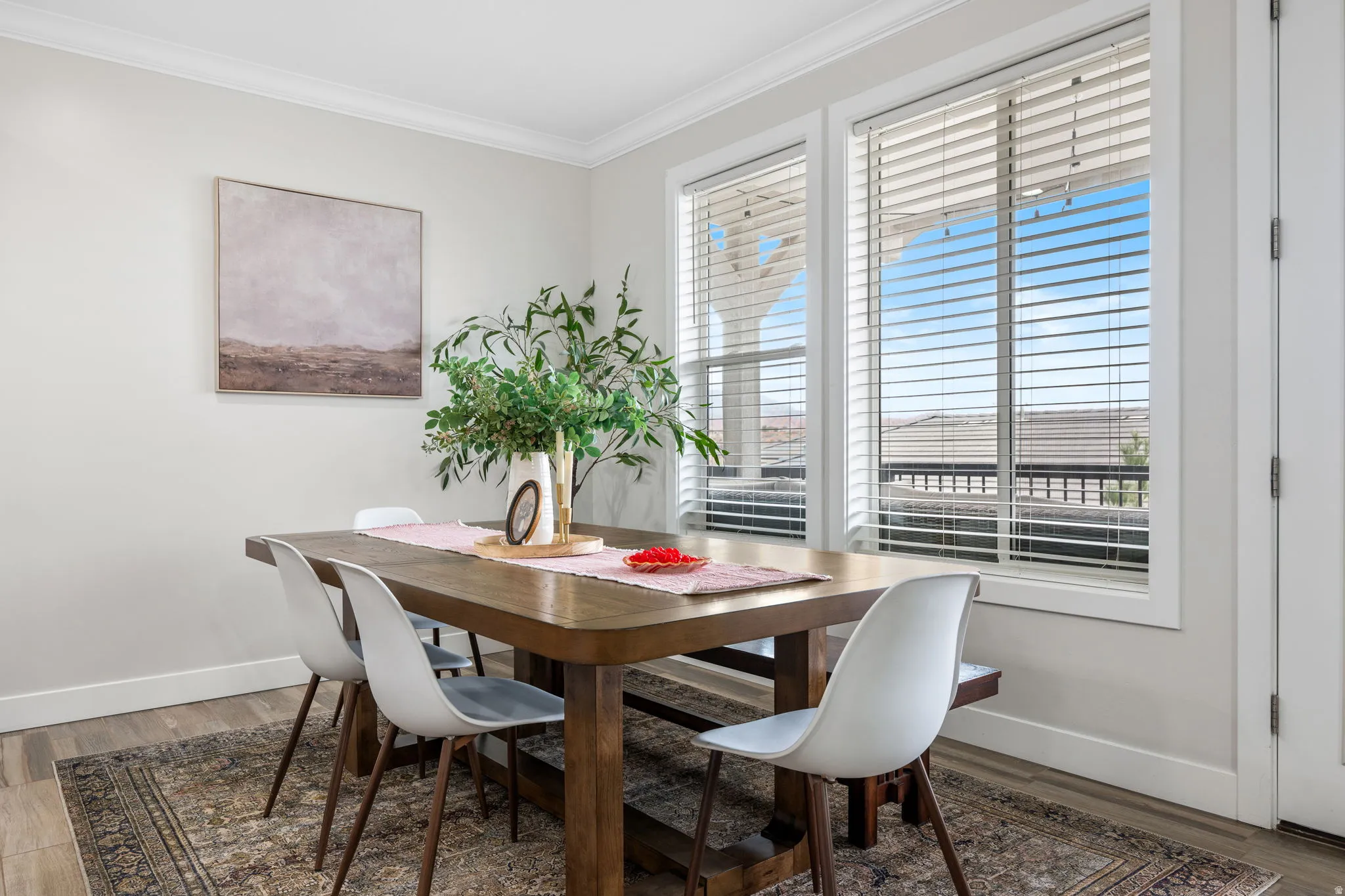 Dining room with ornamental molding and wood finished floors