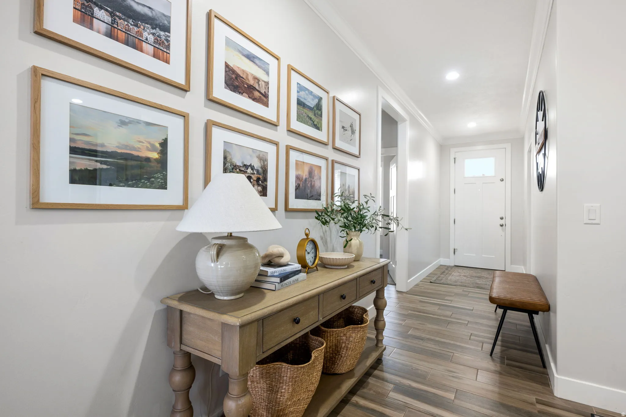 Doorway featuring wood finished floors, crown molding, and recessed lighting