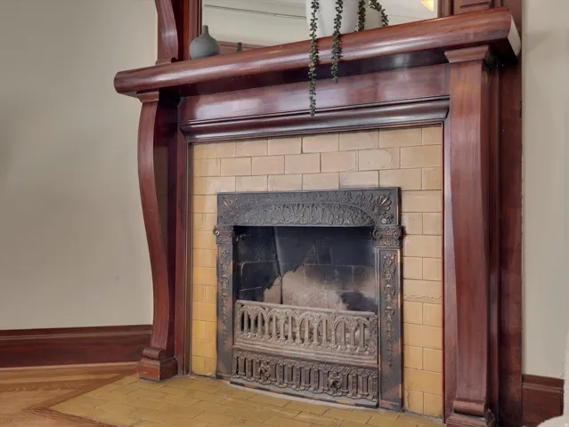 Detailed view of baseboards and a fireplace