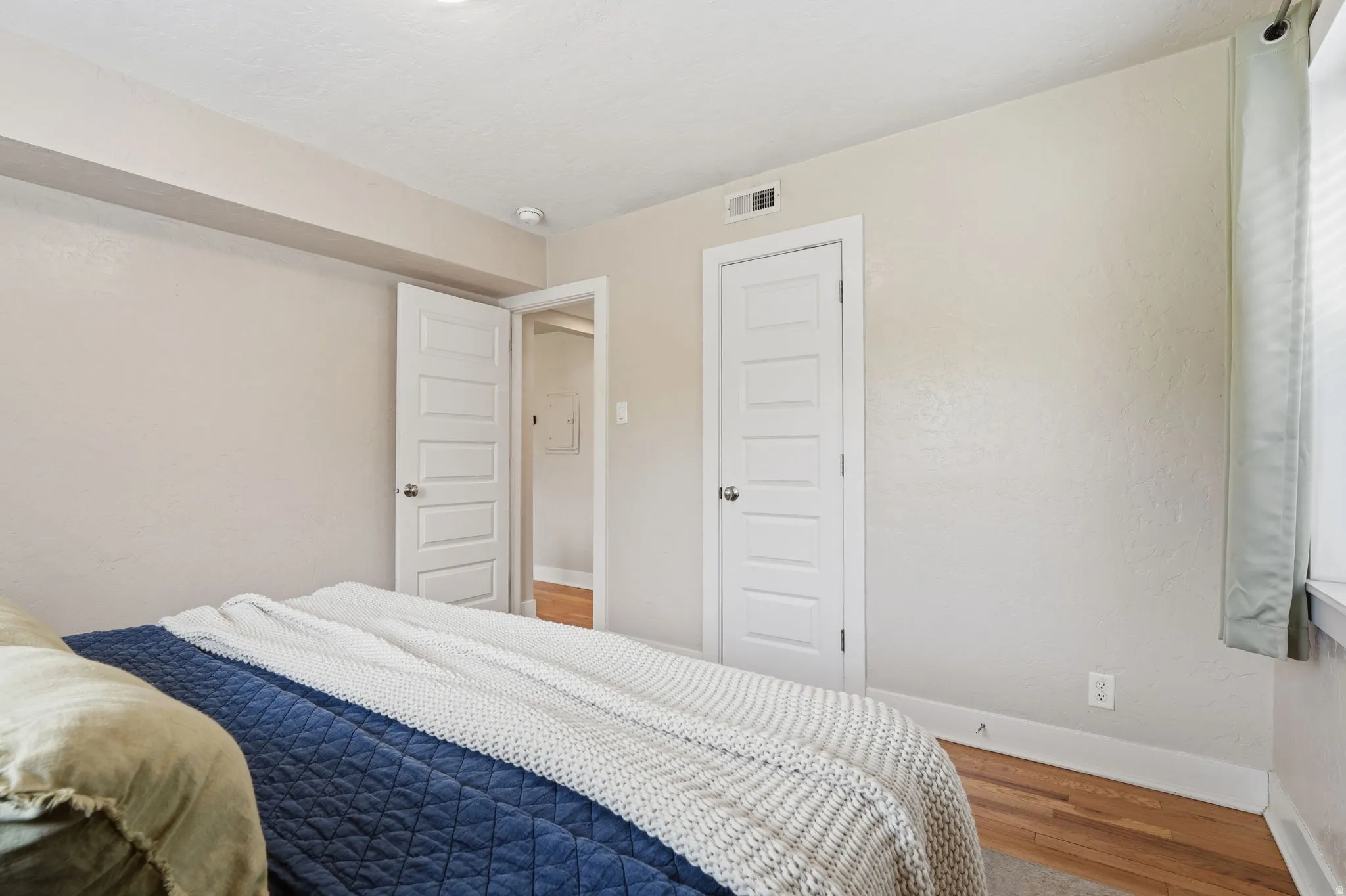 Bedroom featuring baseboards and wood finished floors