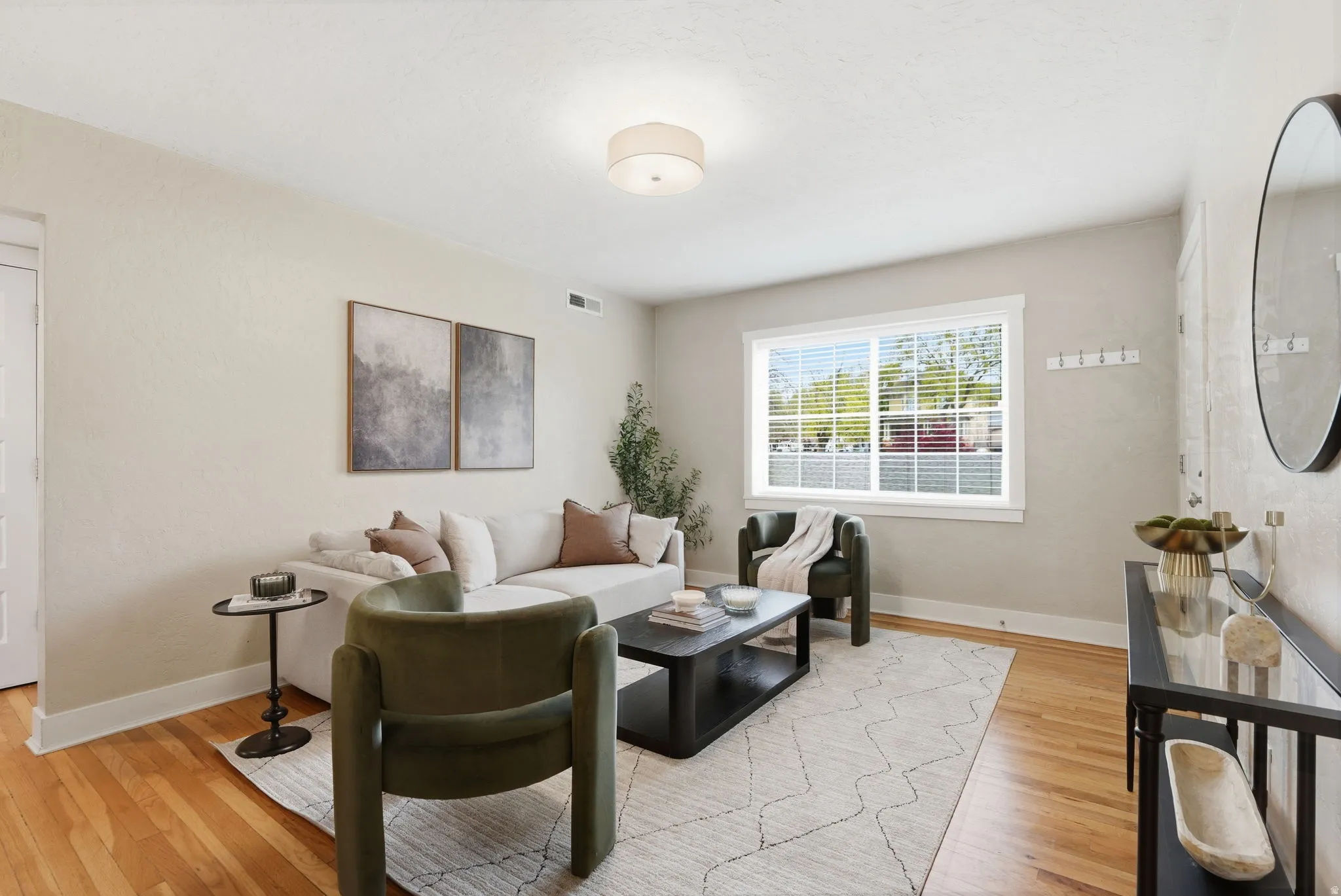 Living area featuring baseboards and light wood-style floors
