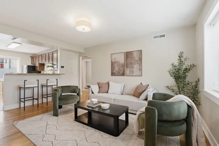 Living room with light wood-type flooring and baseboards