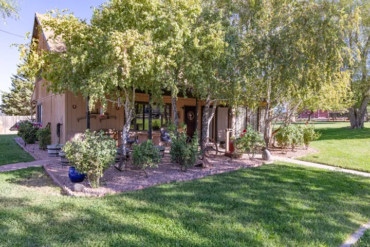 View of front facade featuring a front lawn and a patio