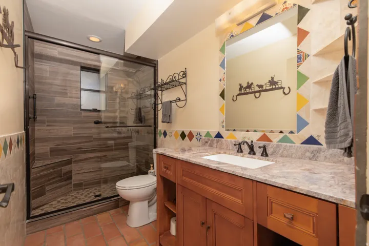 Full bathroom featuring vanity, a shower stall, tile walls, and recessed lighting