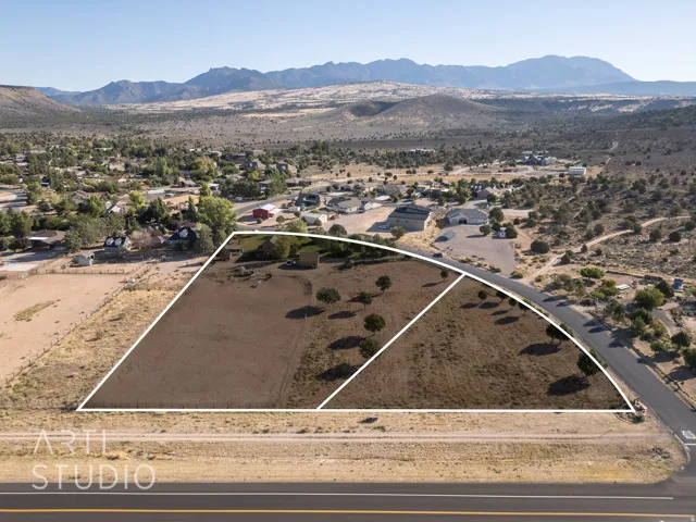 View of rural area with property parcel outlined and nearby suburban area