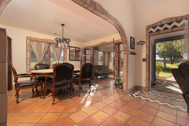 Dining room with hanging lights and light tile patterned flooring