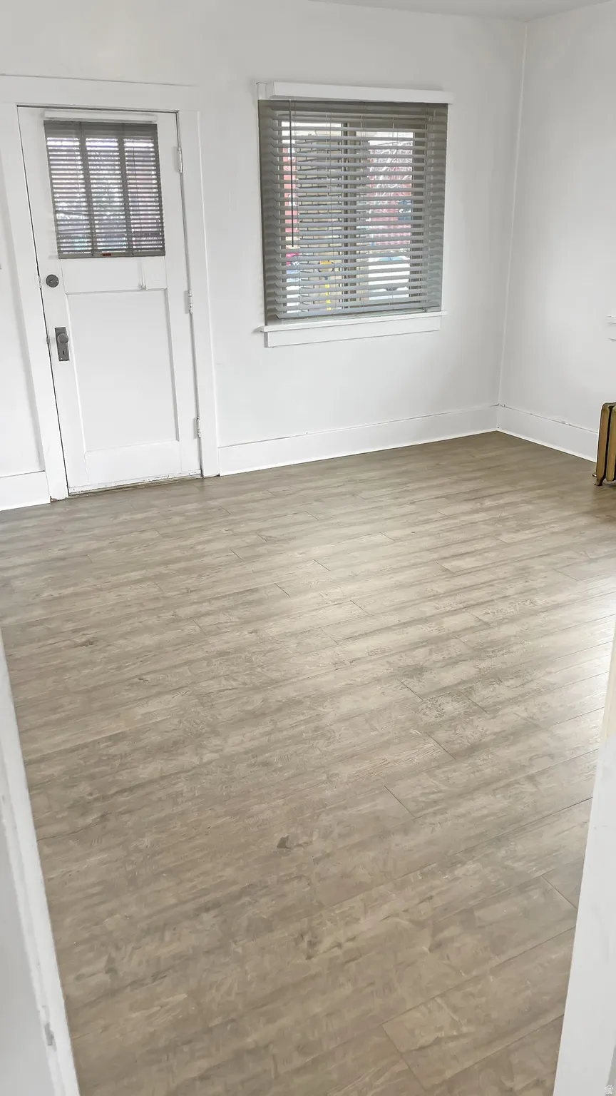 Spare room with light wood finished floors and baseboards