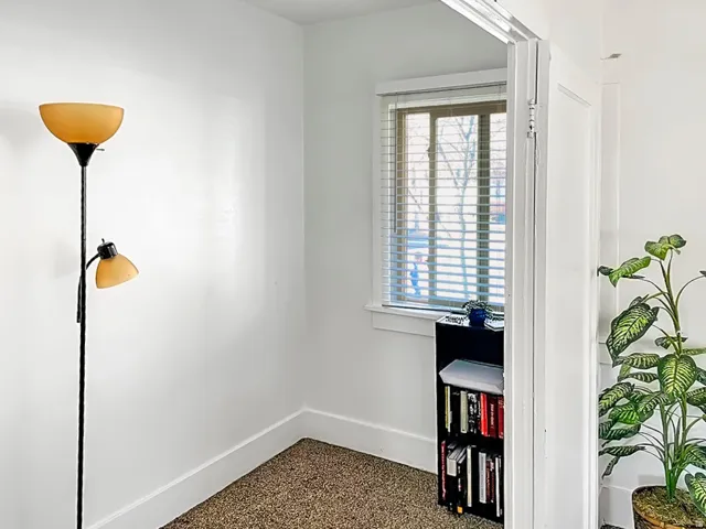 Detailed view of baseboards and speckled floor