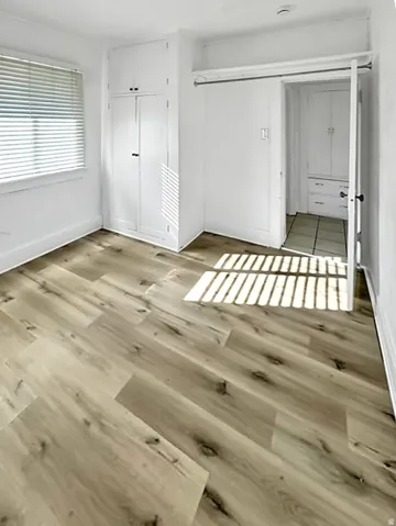 Unfurnished bedroom with a closet and wood finished floors