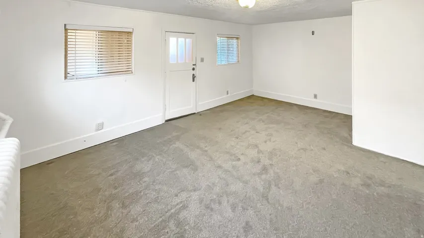 Foyer with carpet and a textured ceiling