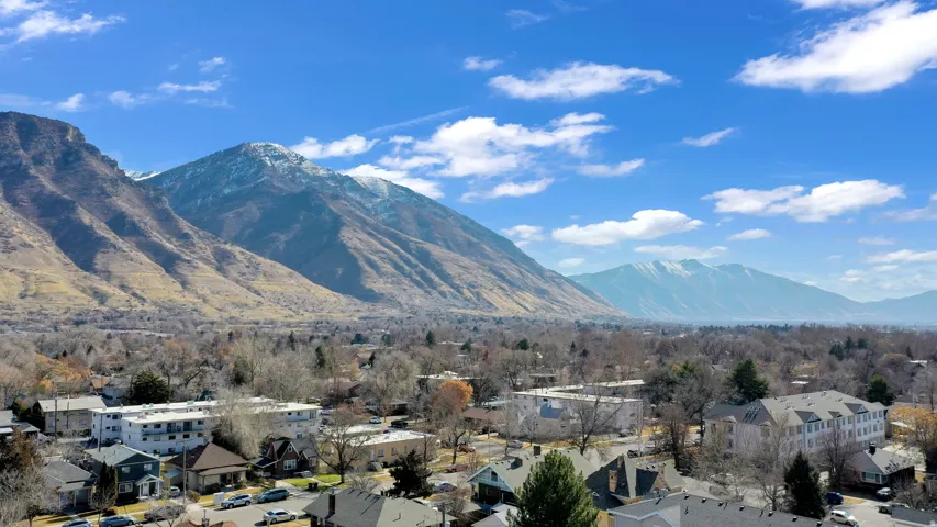 View of mountain backdrop featuring nearby suburban area