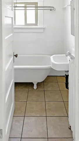 Full bathroom with light tile patterned floors and a sink