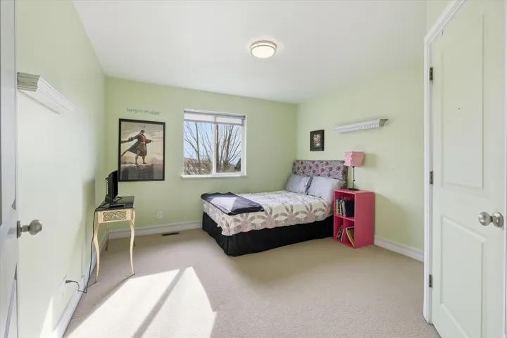 Bedroom featuring baseboards and light colored carpet