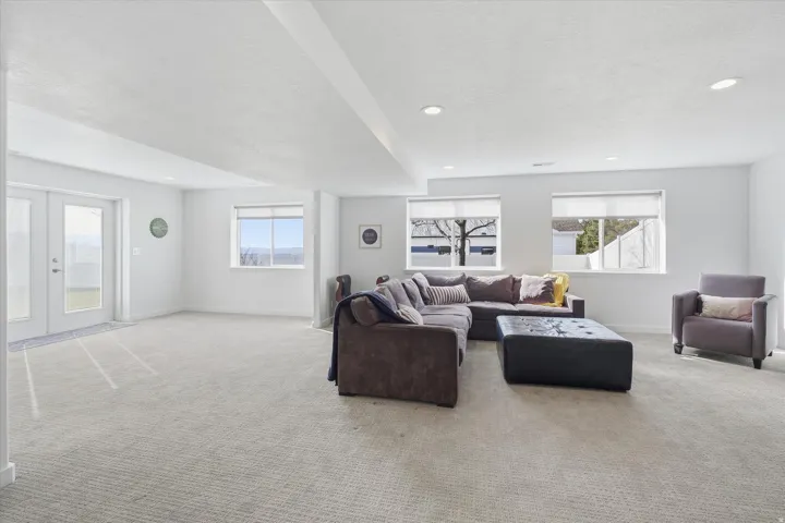 Living room featuring carpet flooring, french doors, recessed lighting, and a textured ceiling