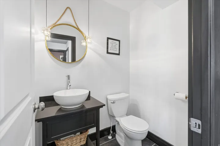 Half bathroom with vanity and tile patterned floors