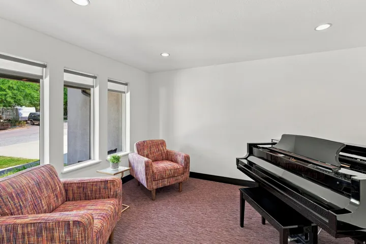 Interior space featuring three vertical windows, recessed ceiling lighting, and a dark baseboard trim