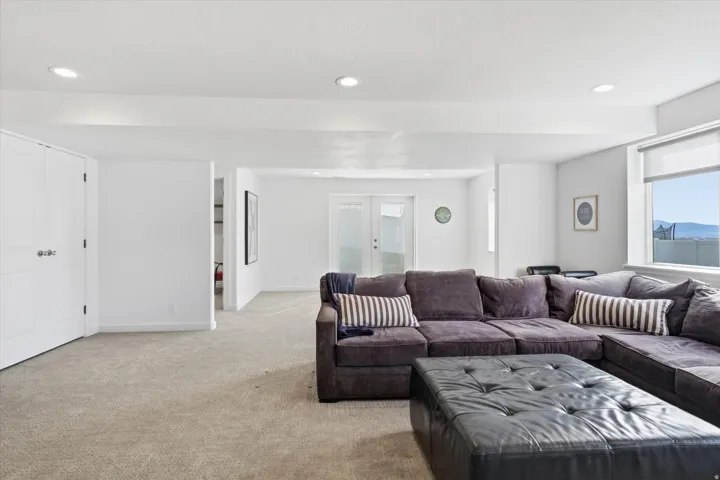 Living area featuring french doors, carpet floors, and recessed lighting