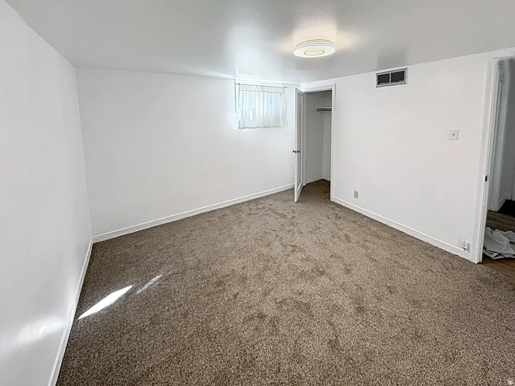 bedroom with carpet and a closet