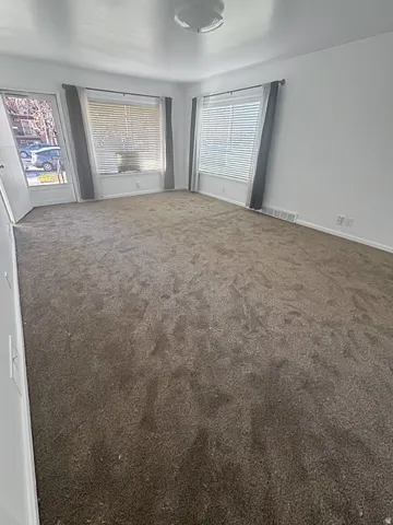 bedroom featuring dark colored carpet and baseboards