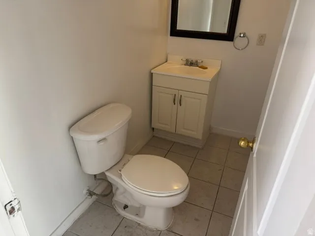 Neutral-toned tile flooring complements white painted walls