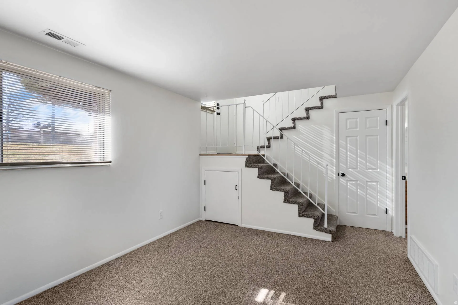 Staircase with carpet flooring and baseboards
