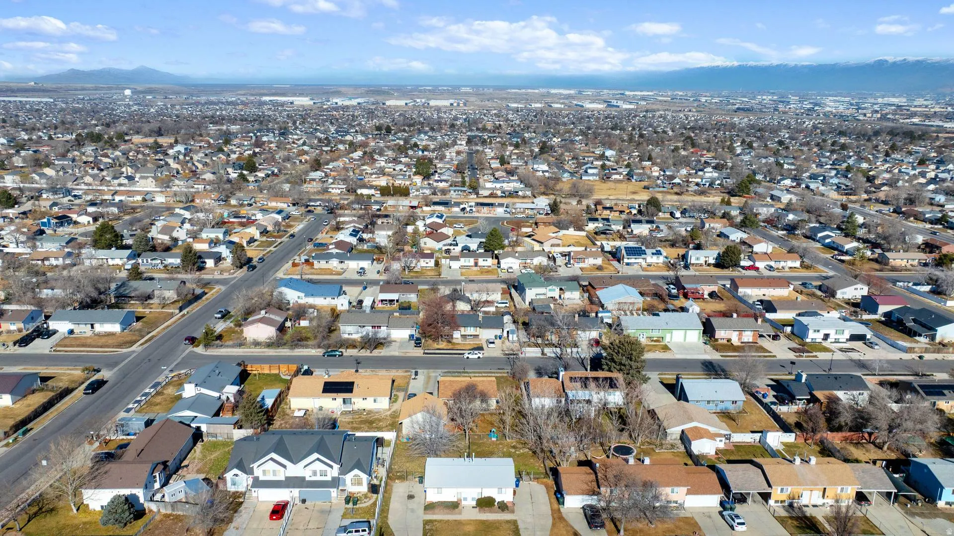 Aerial view of property's location featuring nearby suburban area and a mountain backdrop