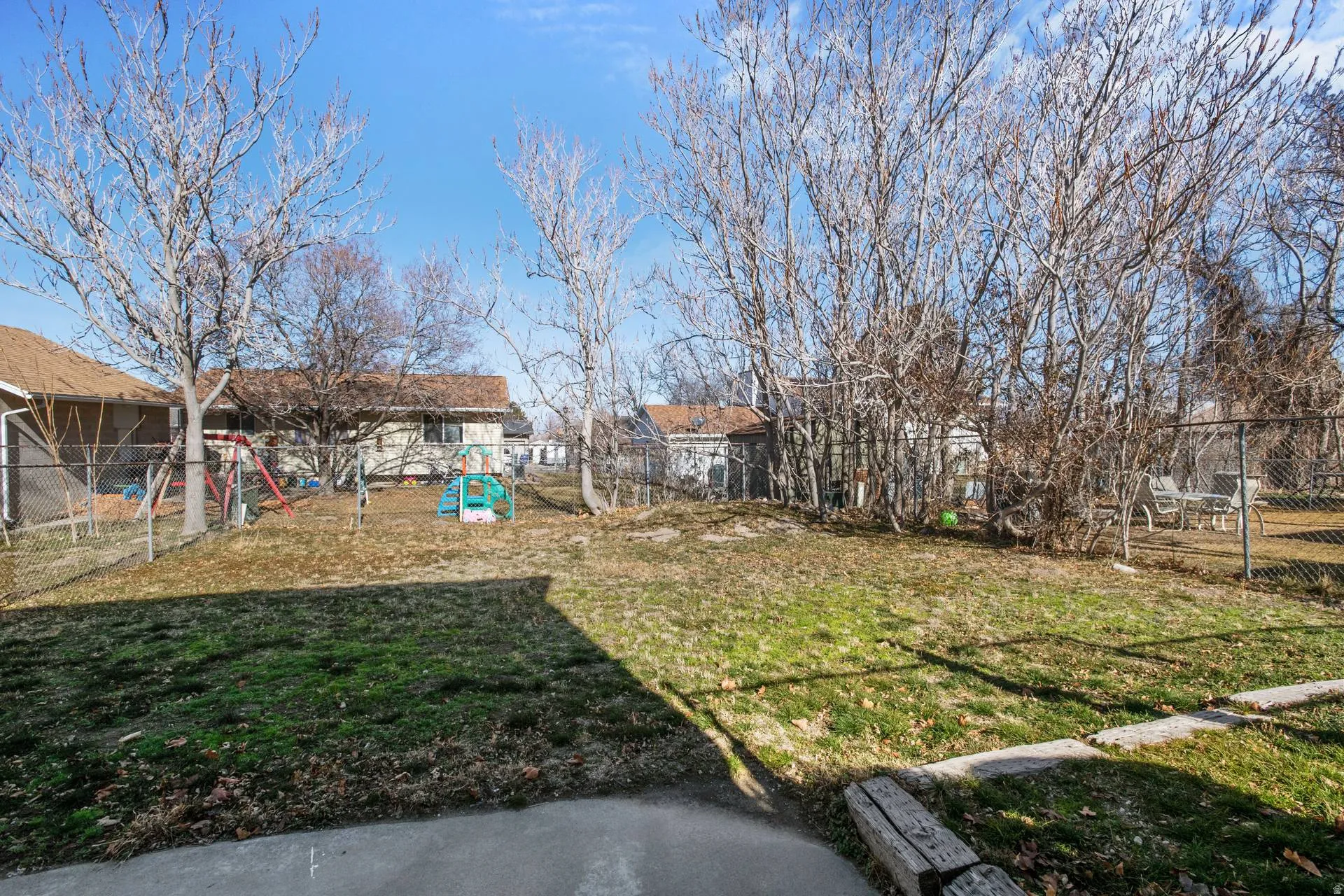 Fenced backyard with a residential view