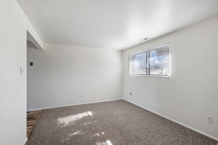 Unfurnished room featuring baseboards and carpet flooring