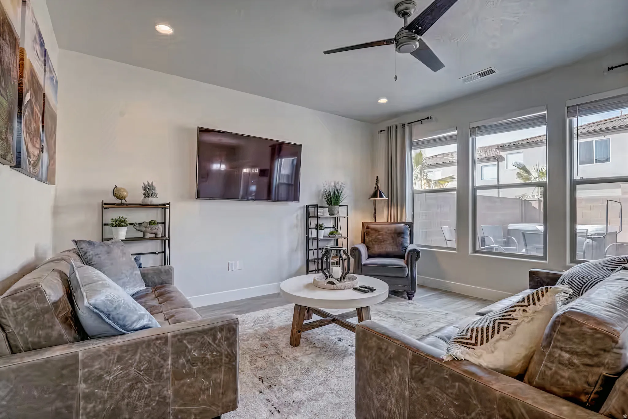 Living room with a ceiling fan, wood finished floors, and recessed lighting