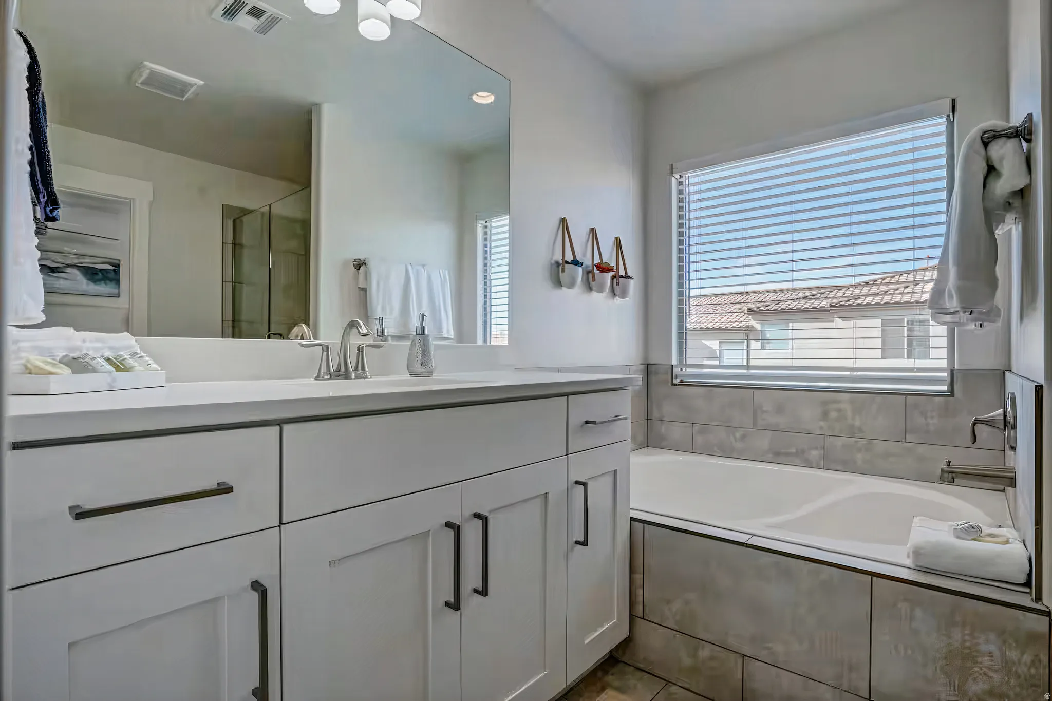 Bathroom featuring vanity, a stall shower, a bath, and recessed lighting
