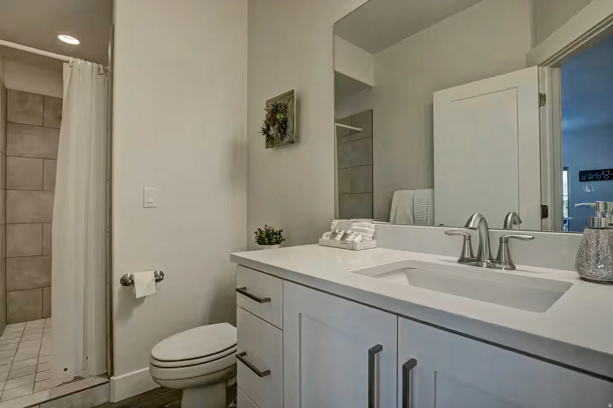 Bathroom featuring vanity and a tile shower