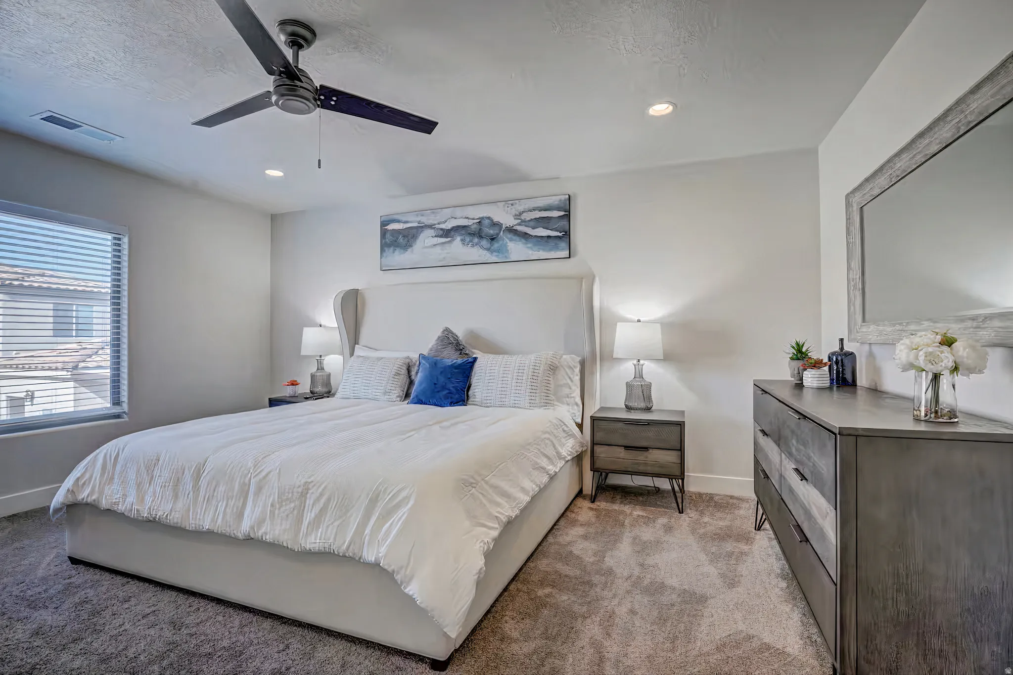 Carpeted bedroom featuring a ceiling fan and recessed lighting