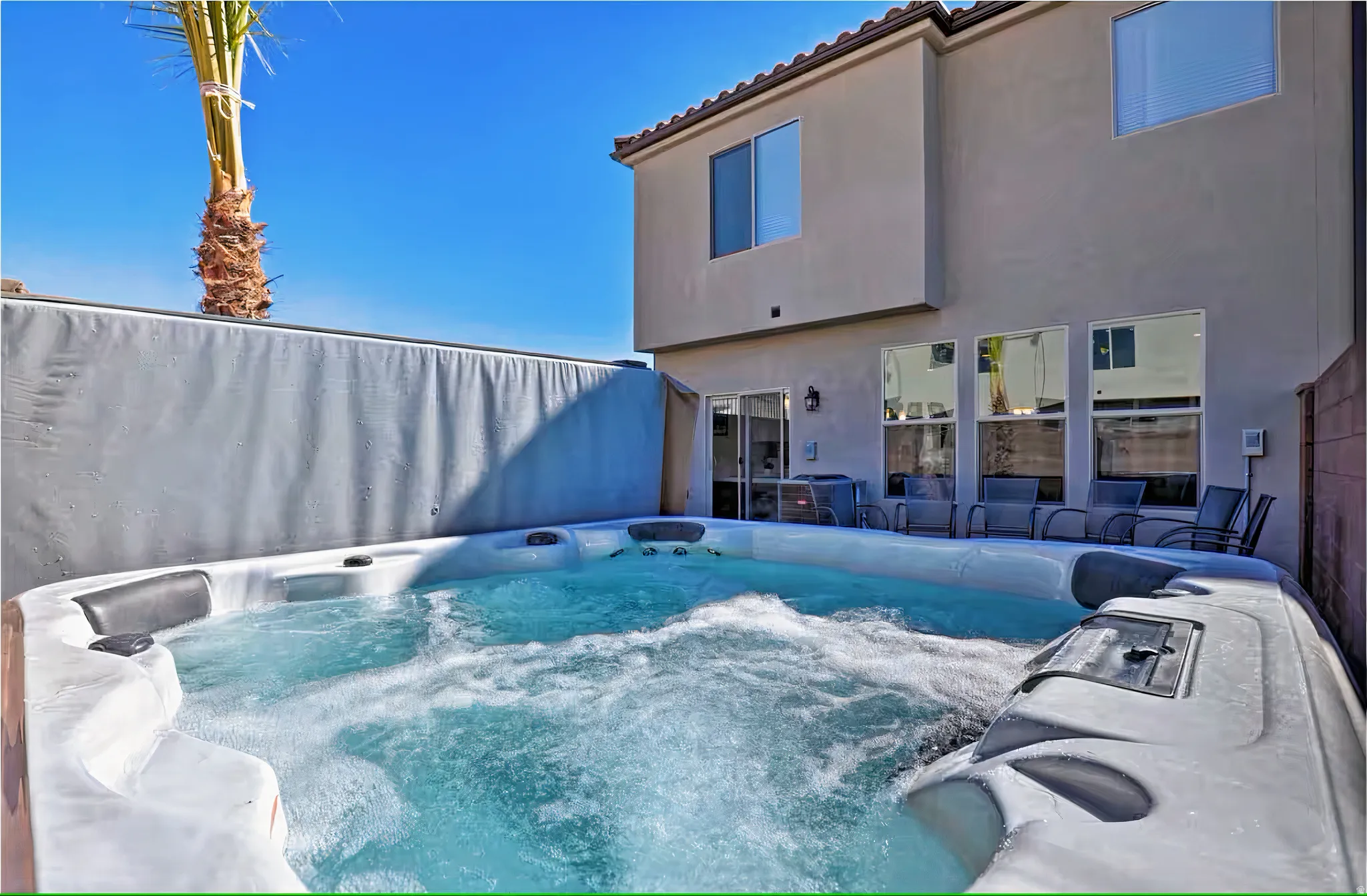 View of pool featuring a hot tub and patio surround